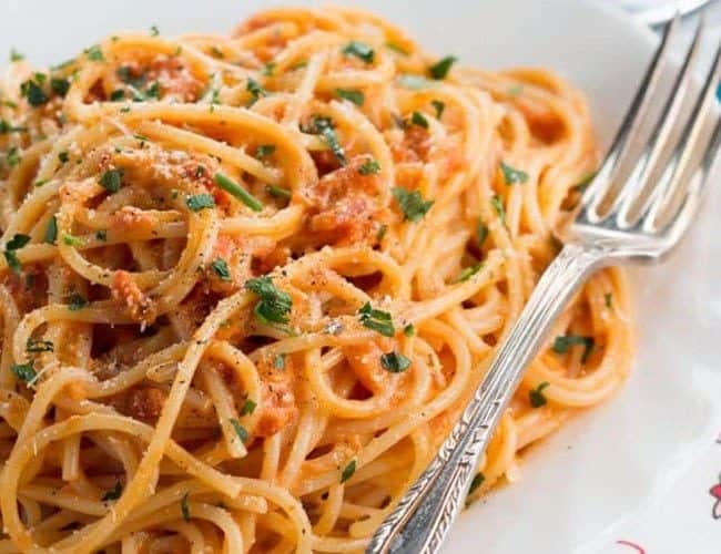 Spaghetti with Skinny Tomato Cream Sauce on a plate with a fork