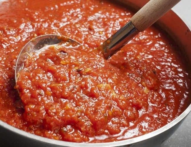 Easy Homemade Tomato Sauce being served with a serving spoon