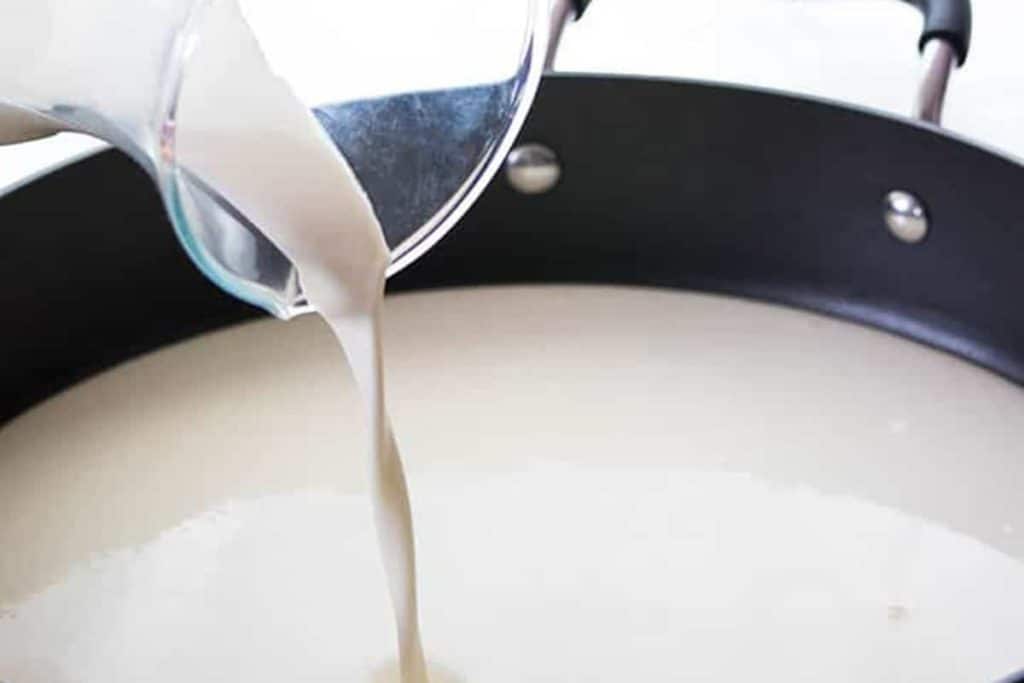 cream being poured into a pot