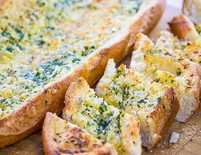 Perfect Garlic Bread cut on a cutting board