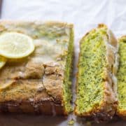 Lemon Poppy Seed Drizzle Cake with three slices cut out of it