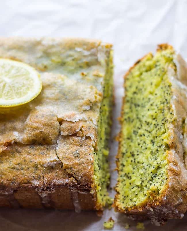 Lemon Poppy Seed Drizzle Cake with three slices cut out of it