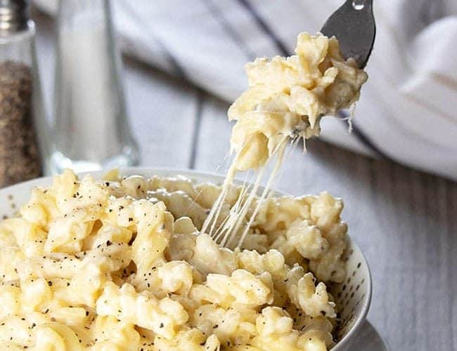 Easy Stovetop a forkful of Creamy Mac and Cheese being taken from the dish