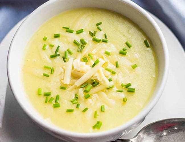 potato leek soup topped with chopped chives and grated cheddar