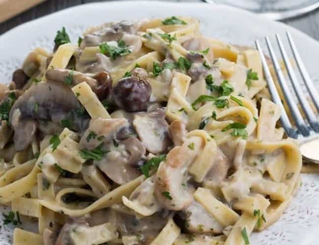 Creamy Tagliatelle and Mushrooms on a plate with a fork