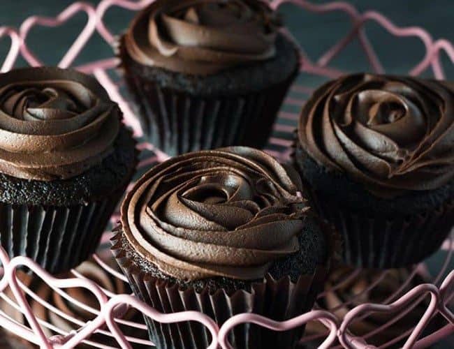 Devil's Food Cupcakes with Dark Chocolate Frostingon a pink cupcake stand