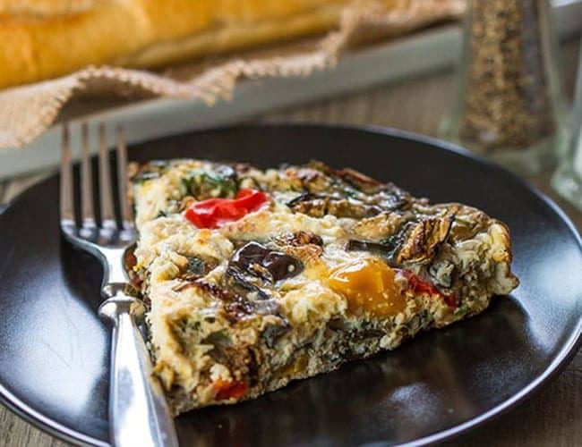 Baked Eggplant Frittata with Red Onion, Peppers & Feta on a dish with a fork