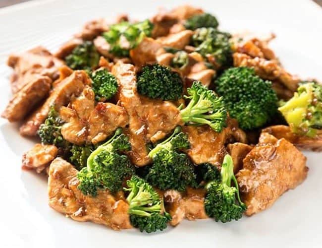 Chinese Chicken and Broccoli piled high on a white plate