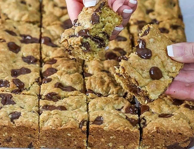 a Chocolate Chip Oatmeal Cookie Bar being broken open