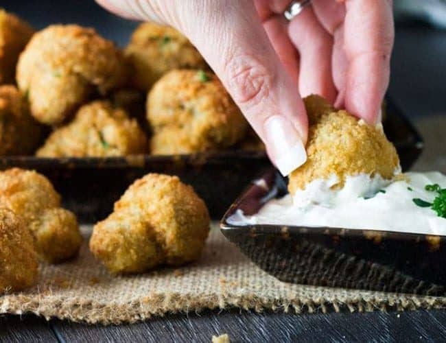 Baked Breaded Garlic Mushrooms being dipped into a sauce