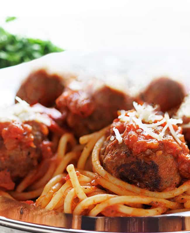 a close up of Spaghetti and Meatballs on a plate with a fork