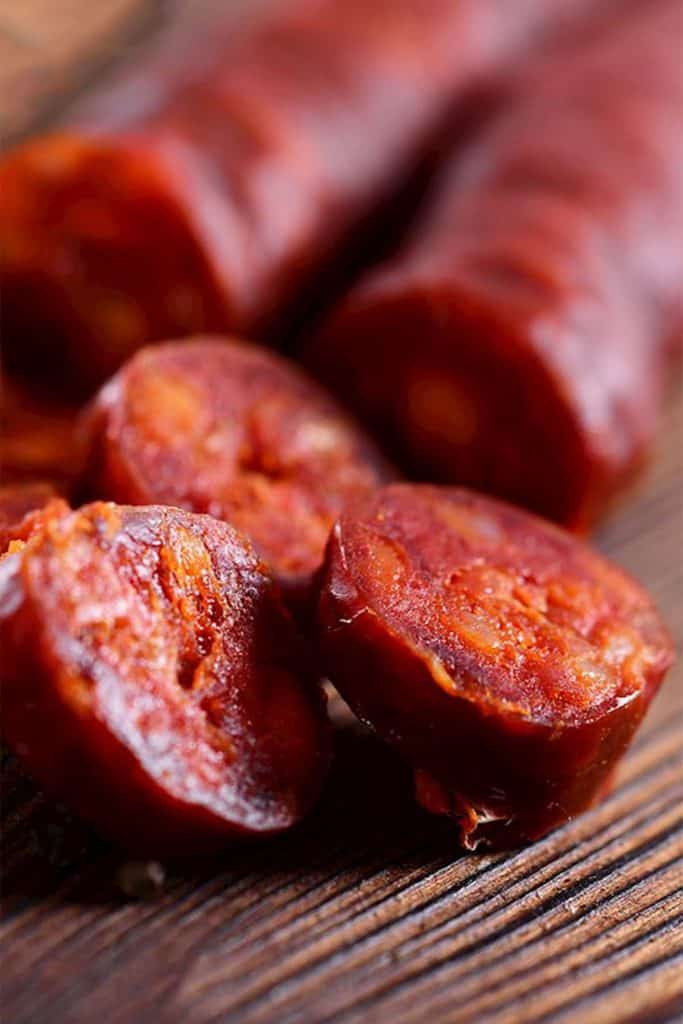 Chorizo sausave cut into slices on a cutting board