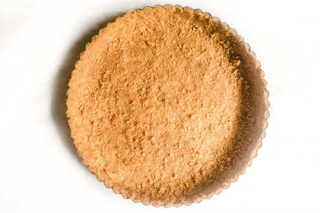 A baked graham cracker crust still in the pan