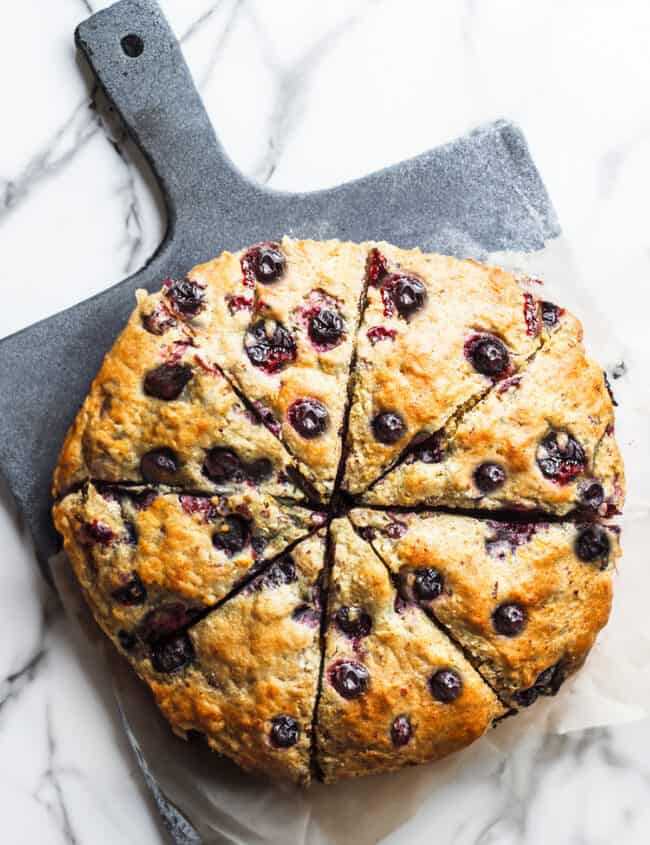 A batch of fresh blueberry scones sliced into wedges