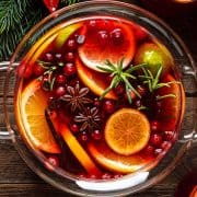 Christmas punch. Festive red cocktail, drink with cranberries and citrus fruits in a punch bowl and glasses