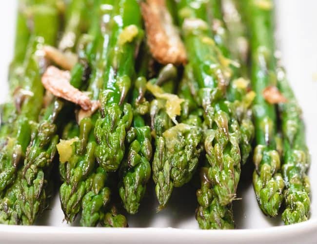 a close up of roasted aspargus on a plate