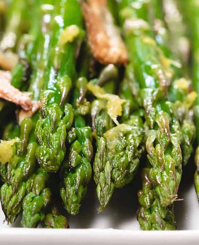 a close up of roasted aspargus on a plate