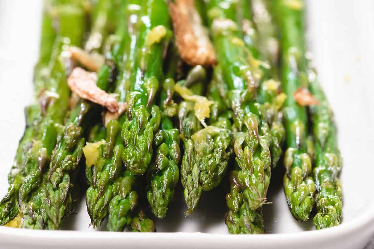 a close up of roasted aspargus on a plate