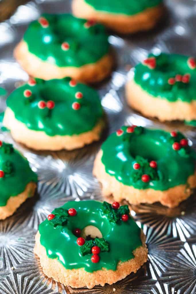 two rows of Christmas Wreath Cookies on a silver baking tray