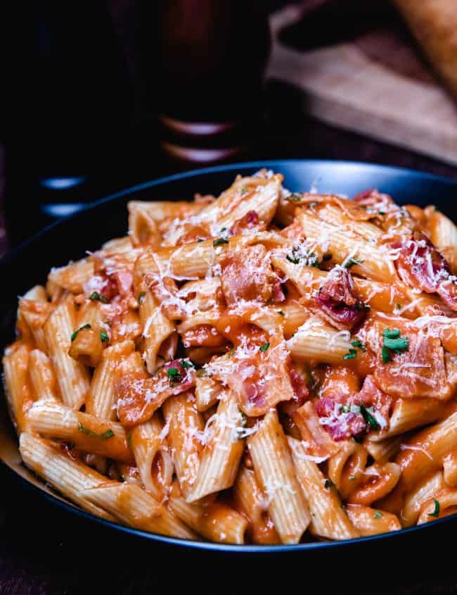 a bowl of tomato cream sauce on pasta.