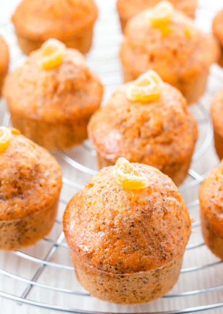 a close up of orange poppy seed cakes ready to eat.