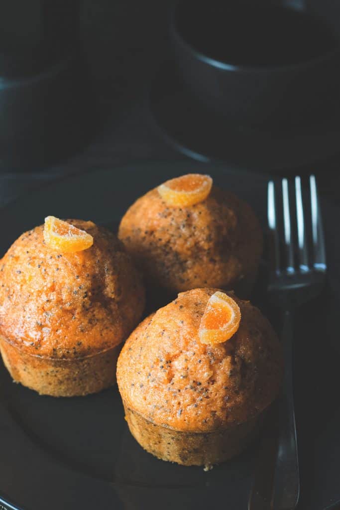 three orange poppy seed cakess