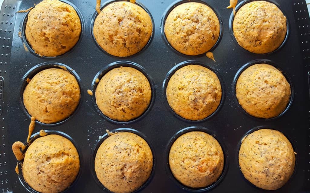 twelve orange poppy seed cakes just out of the oven.