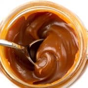 a jar of caramel from above with a spoon in it