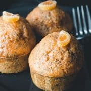 three orange poppy seed cakes with a fork next to them