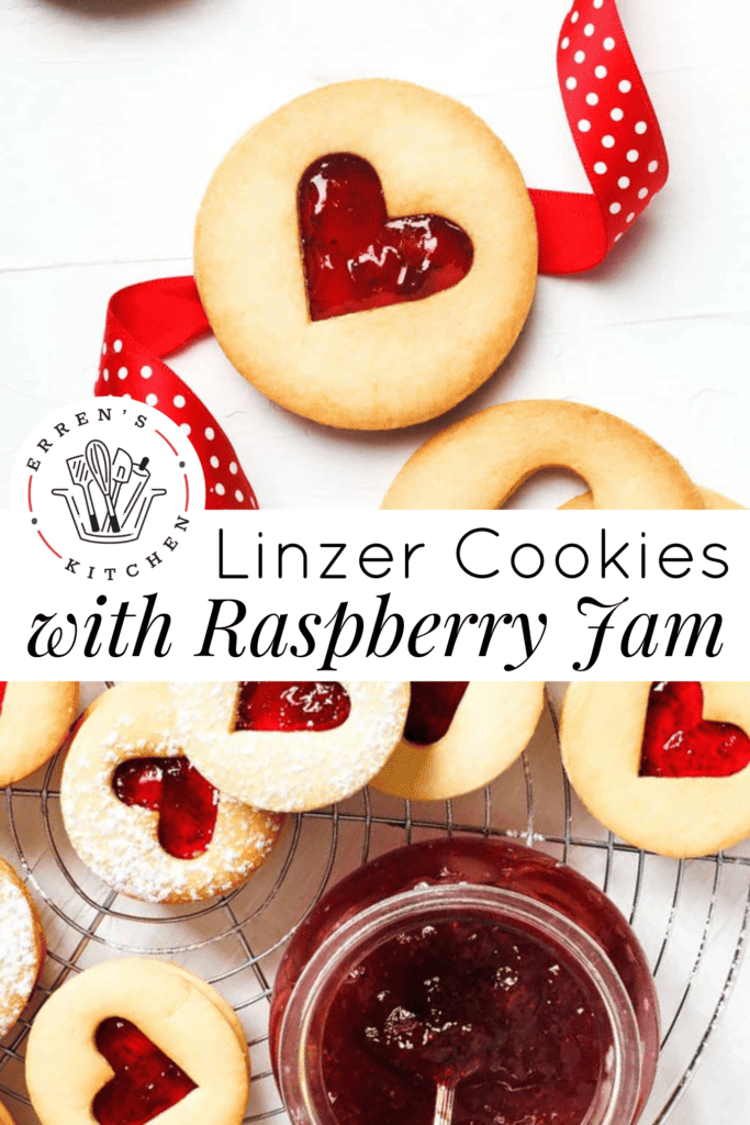 Raspberry linzer cookies with heart shaped cut outs in the center and a far of raspberry jam placed next to them.