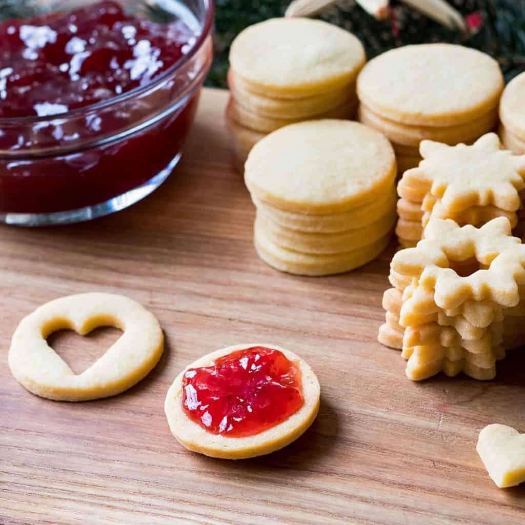 Preparation of traditional Linzer Christmas cookies - filling the cookies with jam