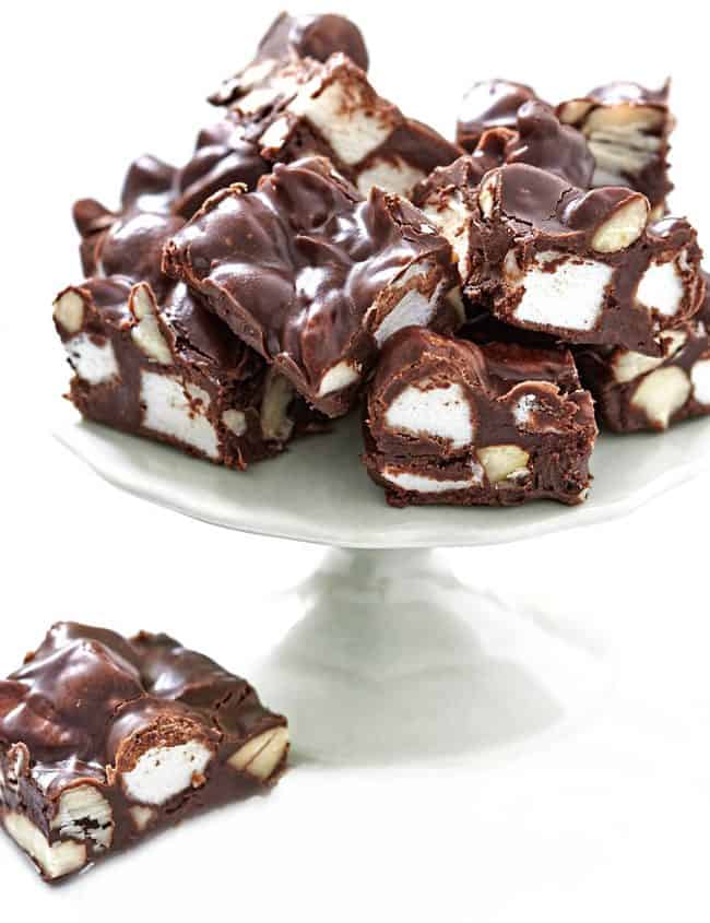 rocky road bars stacked on a dessert stand