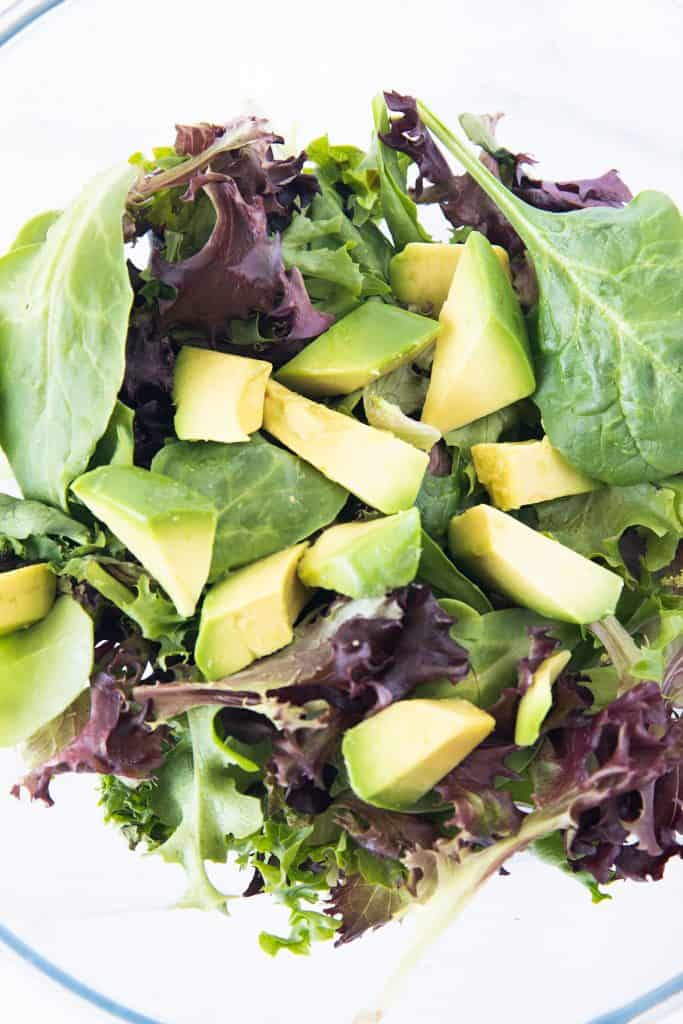 avacado and salad greens in a bowl