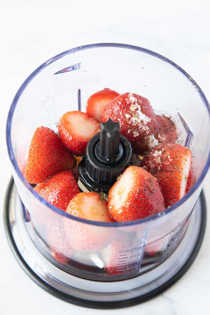 salt and pepper added to strawberry vinaigrette ingredients in a blender