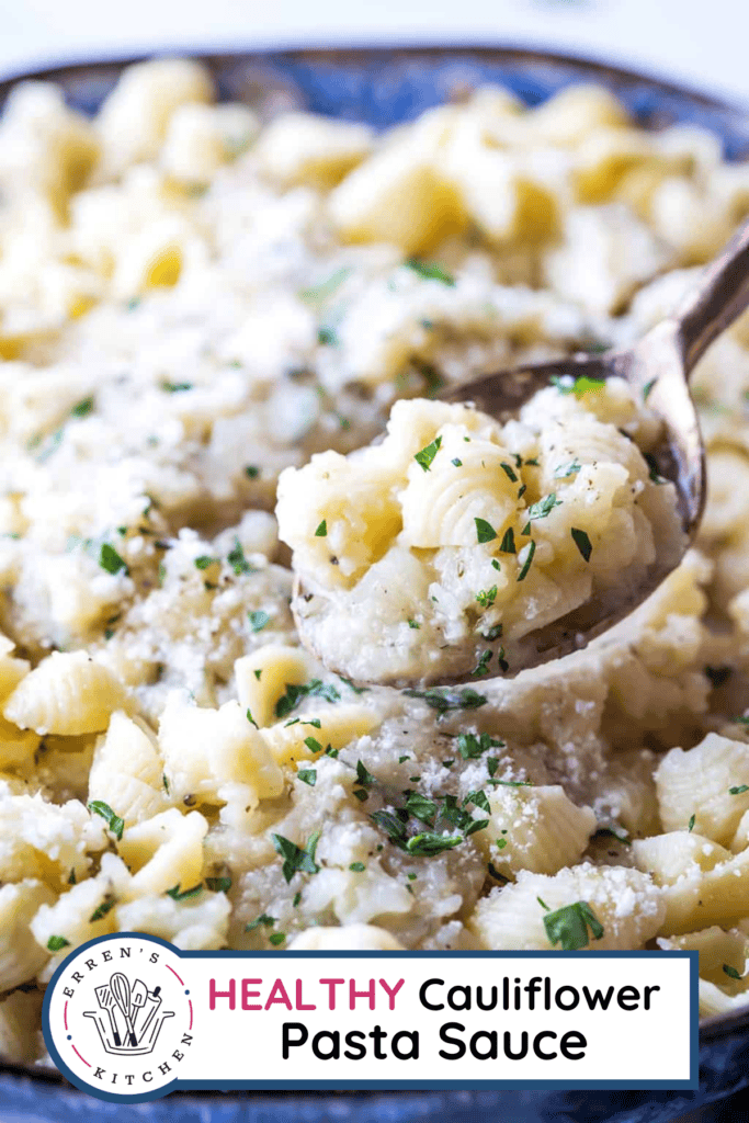 Creamy cauliflower sauce being placed on top of a bowl of pasta with a ladle.