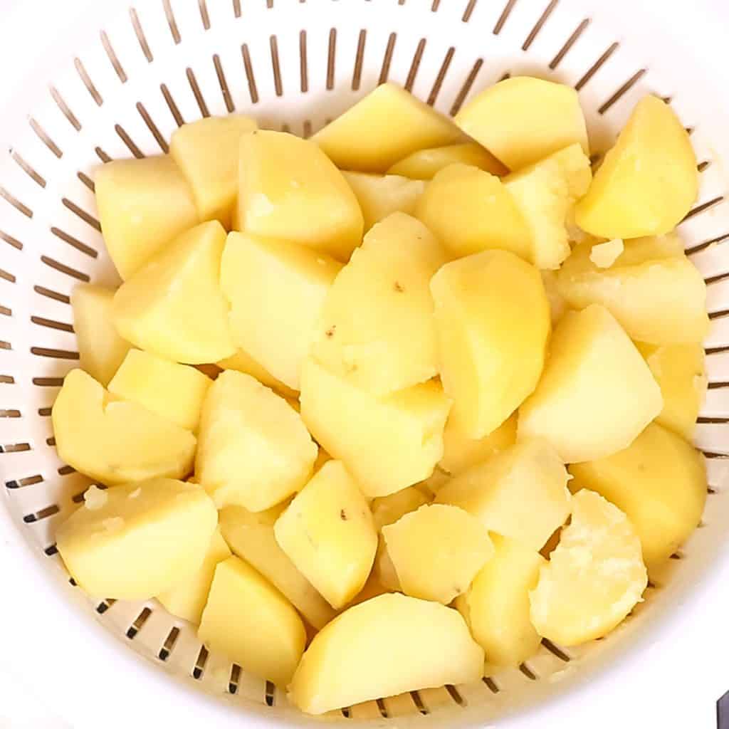 cooked potatoes in a strainer