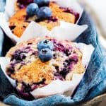 Blueberry muffins with a crumb topping in a serving tray.