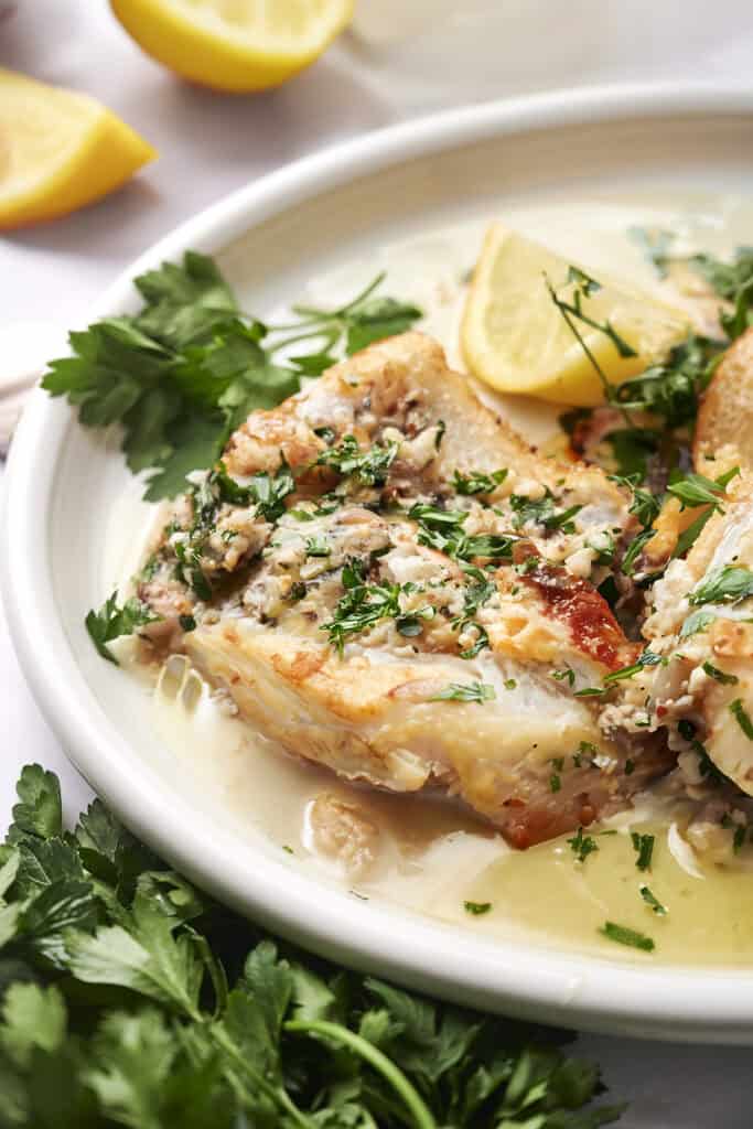 Cod in garlic butter sauce with lemon slices