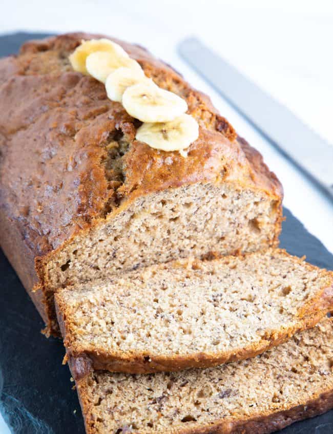 a banana bread loaf sliced and ready to eat