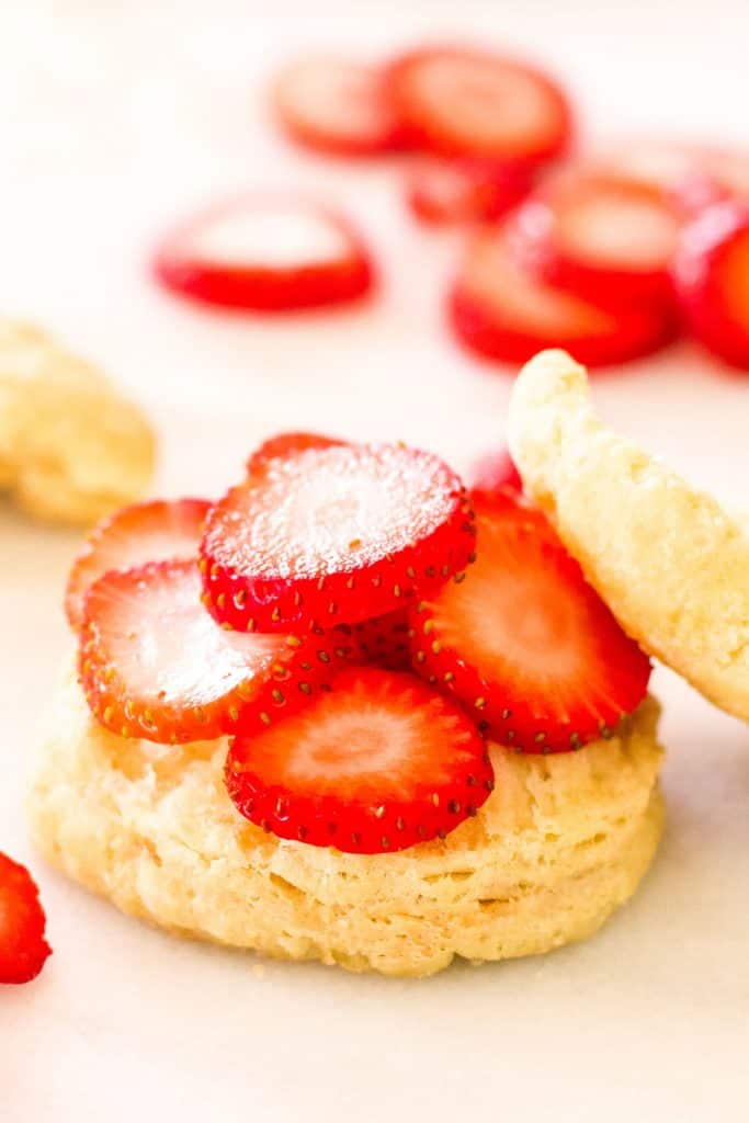 sliced strawberries on a biscuit