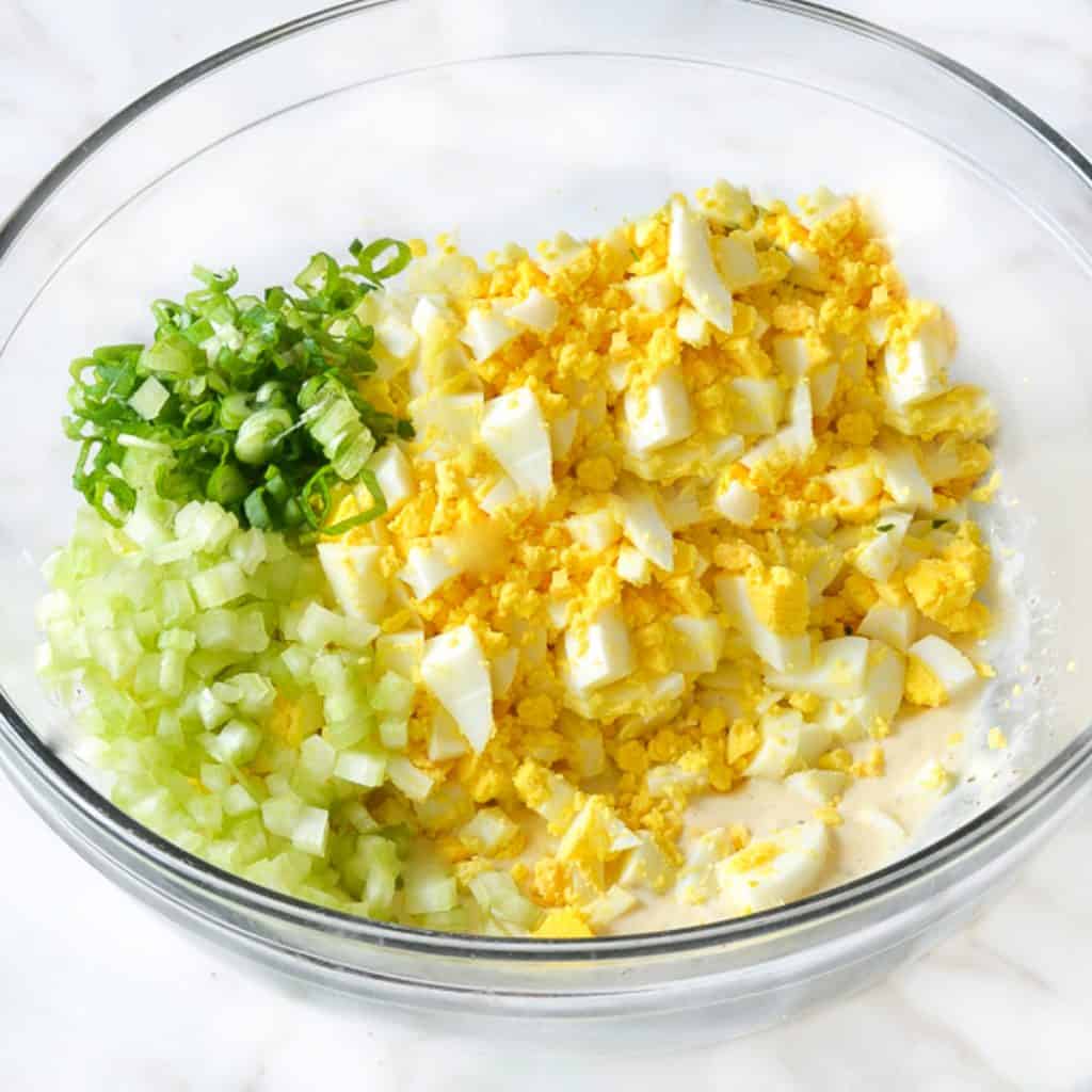 eggs, chives and green onions chopped in a bowl