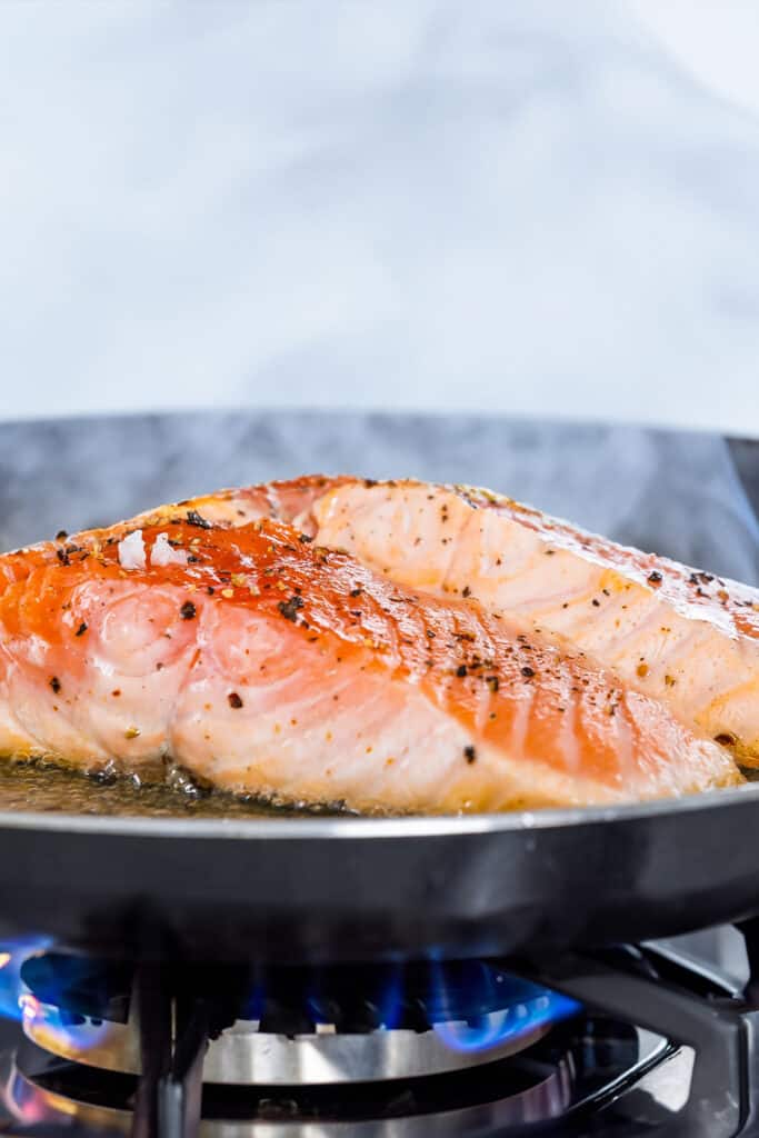 salmon cooking in a skillet