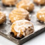 spiced German cookies on a baking tray drizzled with glaze