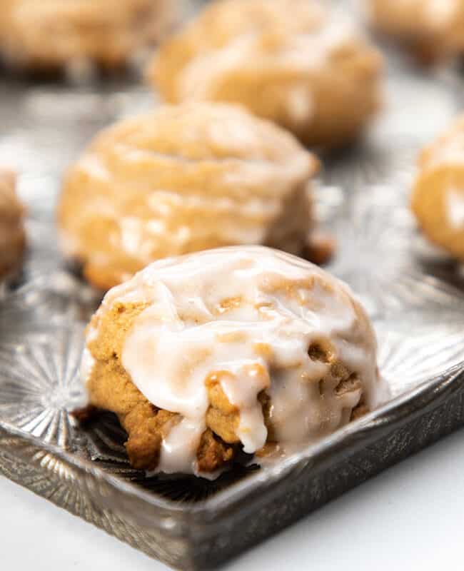 spiced German cookies on a baking tray drizzled with glaze