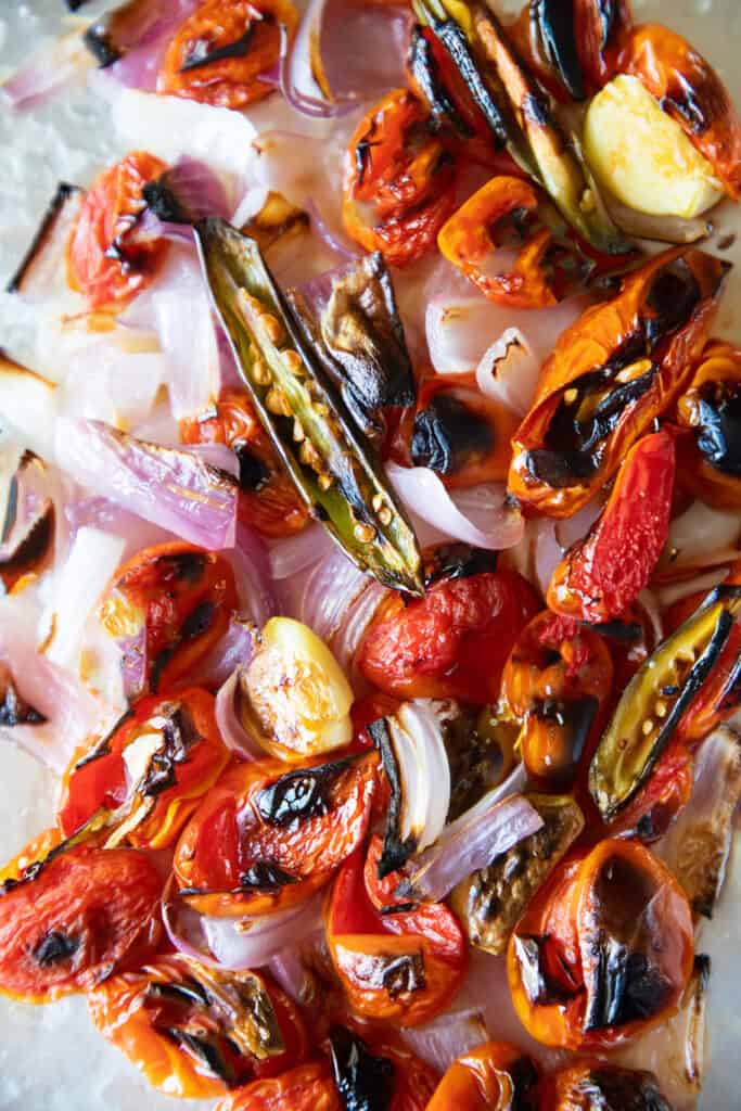 the roasted vegetables for peri peri chicken sauce on the pan showing some charring.