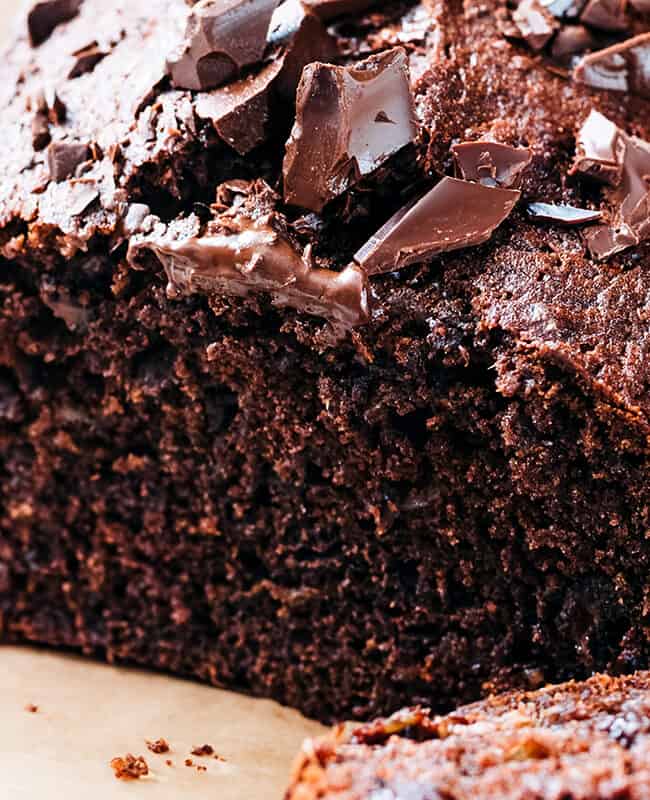 a close up image of A sliced chocolate banana cake topped with chopped chocolate.