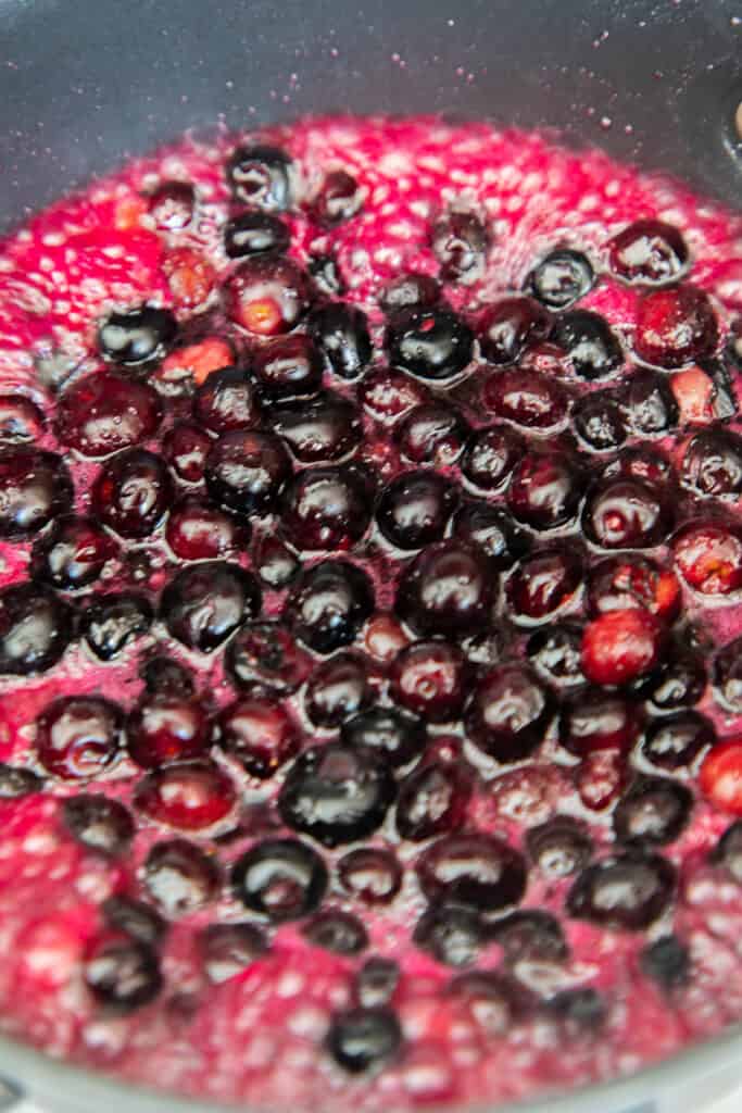 blueberries and sugar boiling in a pan