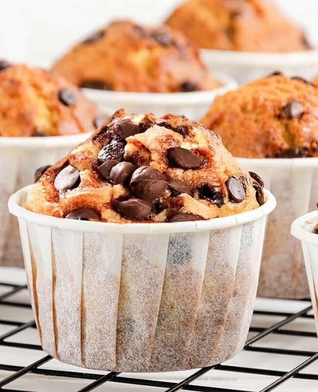 a batch of chocolate chip muffins cooling on a cooling rack