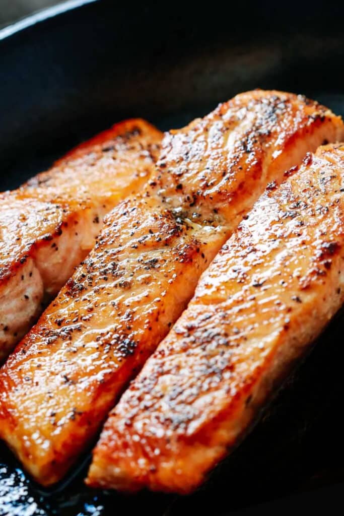 seared salmon fillets in a pan