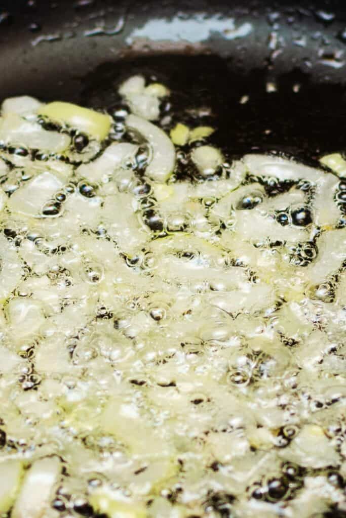 onions cooking in poil in a pan